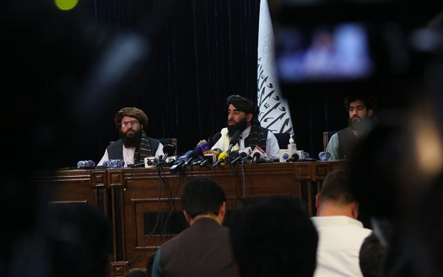 8月17日，在阿富汗首都喀布尔，阿富汗塔利班发言人扎比乌拉·穆贾希德（后中）出席塔利班进入喀布尔后举行的首次记者会。
